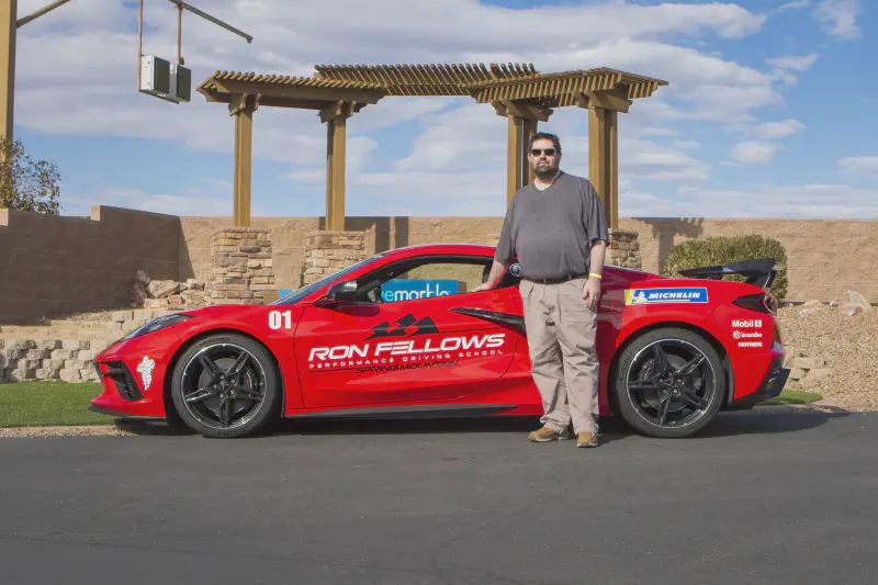 Standing with a Ron Fellows school C8 Corvette